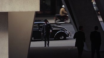 Movie still from “Walkabout” (1971), directed by Nicolas Roeg – A man in a suit and a hat walking down the street; Wide shot, High angle