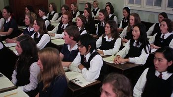 Movie still from “Walkabout” (1971), directed by Nicolas Roeg – A large group of students sitting in a classroom together; Medium shot, High angle