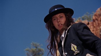 Movie still from “Walkabout” (1971), directed by Nicolas Roeg – A woman with long brown hair wearing a hat; Close Up shot, Low angle