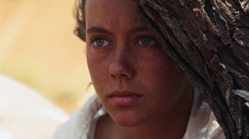 Movie still from “Walkabout” (1971), directed by Nicolas Roeg – A person with blue eyes; Close Up shot, Over the shoulder angle