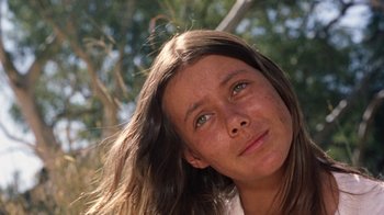 Movie still from “Walkabout” (1971), directed by Nicolas Roeg – A person with long brown hair; Close Up shot, Low angle