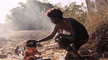 Movie still from “Walkabout” (1971), directed by Nicolas Roeg – A man and a child on the beach; Medium shot, Over the shoulder angle