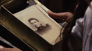 Movie still from “Walkabout” (1971), directed by Nicolas Roeg – An old photo of a man in uniform is held up; Extreme Close Up shot, Over the shoulder angle