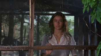 Movie still from “Walkabout” (1971), directed by Nicolas Roeg – A woman standing in front of a wooden fence; Medium shot, Low angle
