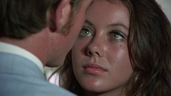 Movie still from “Walkabout” (1971), directed by Nicolas Roeg – A man and a woman looking at each other with green eyes; Close Up shot, Over the shoulder angle