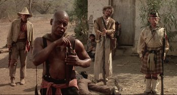 Movie still from “Walker” (1987), directed by Alex Cox – A man with a pipe in his mouth in front of two other men; Medium shot, Low angle