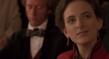 Movie still from “Walker” (1987), directed by Alex Cox – A man and a woman in formal attire; Close Up shot, Over the shoulder angle