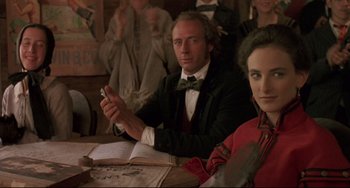 Movie still from “Walker” (1987), directed by Alex Cox – A man and a woman sitting at a table; Close Up shot, Over the shoulder angle