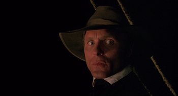 Movie still from “Walker” (1987), directed by Alex Cox – A person wearing a hat; Close Up shot, Low angle