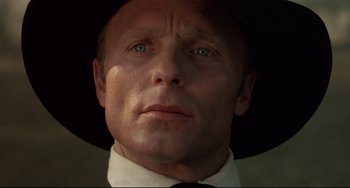 Movie still from “Walker” (1987), directed by Alex Cox – A person wearing a hat; Close Up shot, Low angle