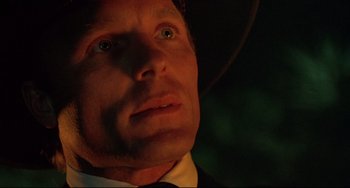 Movie still from “Walker” (1987), directed by Alex Cox – A person wearing a suit and tie; Close Up shot, Low angle