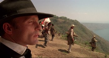 Movie still from “Walker” (1987), directed by Alex Cox – A group of people standing on top of a hill; Close Up shot, Low angle