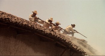 Movie still from “Walker” (1987), directed by Alex Cox – A group of men in white shirts and straw hats are shooting guns; Wide shot, Low angle
