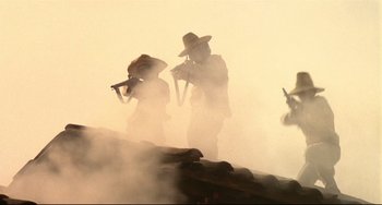Movie still from “Walker” (1987), directed by Alex Cox – A group of people standing on top of a hill; Wide shot, Low angle