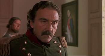 Movie still from “Walker” (1987), directed by Alex Cox – A person wearing a uniform; Close Up shot, Low angle