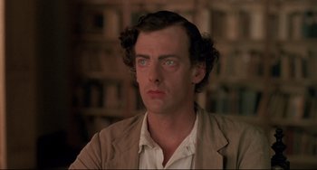 Movie still from “Walker” (1987), directed by Alex Cox – A person wearing a suit and tie; Close Up shot, High angle