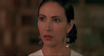 Movie still from “Walker” (1987), directed by Alex Cox – A person wearing a white shirt; Close Up shot, Over the shoulder angle