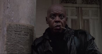 Movie still from “Walker” (1987), directed by Alex Cox – A man smoking a cigarette while wearing a leather jacket; Close Up shot, Low angle