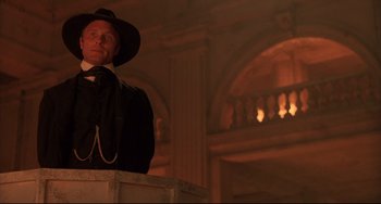 Movie still from “Walker” (1987), directed by Alex Cox – A man wearing a hat and a black suit; Medium shot, Low angle