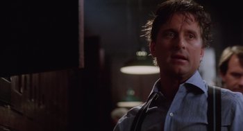 Movie still from “Wall Street” (1987), directed by Oliver Stone – A person wearing a blue shirt; Close Up shot, Low angle