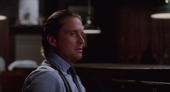 Movie still from “Wall Street” (1987), directed by Oliver Stone – A person wearing a shirt and a tie; Close Up shot, Over the shoulder angle