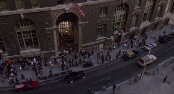 Movie still from “Wall Street” (1987), directed by Oliver Stone – An aerial view of a crowd of people walking on a street; Extreme Wide shot, High angle