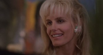 Movie still from “Wall Street” (1987), directed by Oliver Stone – A person with blond hair; Close Up shot, Low angle