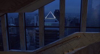 Movie still from “Wall Street” (1987), directed by Oliver Stone – A view of a city at night through a window; Extreme Wide shot, High angle