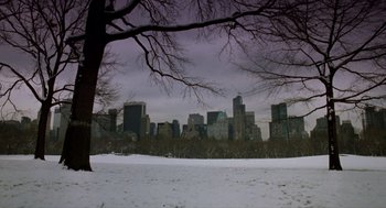 Movie still from “Wall Street” (1987), directed by Oliver Stone – A view of a city skyline from across a snow covered field; Extreme Wide shot, Low angle