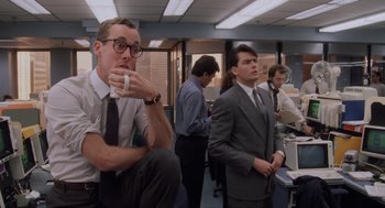 Movie still from “Wall Street” (1987), directed by Oliver Stone – A group of men in suits and ties in an office setting; Medium shot, Low angle
