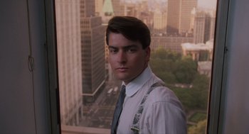 Movie still from “Wall Street” (1987), directed by Oliver Stone – A man in a white dress shirt and a tie; Close Up shot, Low angle