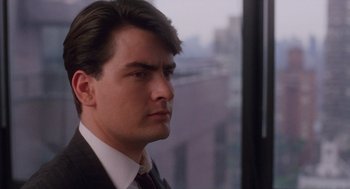 Movie still from “Wall Street” (1987), directed by Oliver Stone – A person wearing a suit and tie; Close Up shot, Low angle