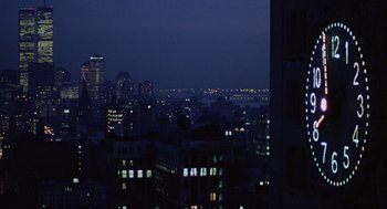 Movie still from “Wall Street” (1987), directed by Oliver Stone – A view of a city at night from a high rise building; Extreme Wide shot, High angle