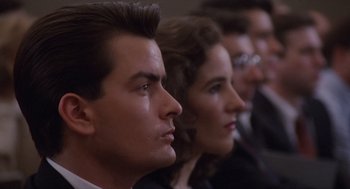 Movie still from “Wall Street” (1987), directed by Oliver Stone – A man and a woman sitting next to each other; Close Up shot, Low angle