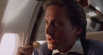 Movie still from “Wall Street” (1987), directed by Oliver Stone – A person holding a banana on a stick; Close Up shot, Low angle
