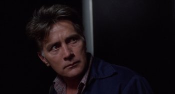 Movie still from “Wall Street” (1987), directed by Oliver Stone – A person wearing a jacket; Close Up shot, Low angle