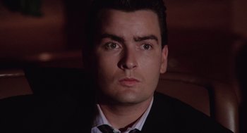 Movie still from “Wall Street” (1987), directed by Oliver Stone – A person wearing a suit and tie; Close Up shot, Low angle