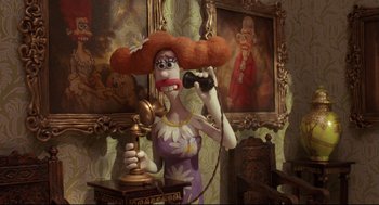 Movie still from “Wallace & Gromit: The Curse of the Were-Rabbit” (2005), directed by Nick Park – A statue of a woman holding a phone in her hand; Medium shot, High angle