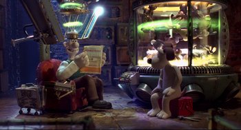Movie still from “Wallace & Gromit: The Curse of the Were-Rabbit” (2005), directed by Nick Park – A couple of cartoon characters sitting in front of a fireplace; Wide shot, High angle