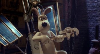 Movie still from “Wallace & Gromit: The Curse of the Were-Rabbit” (2005), directed by Nick Park – A toy dog holding a wrench in his hands; Medium shot, Low angle