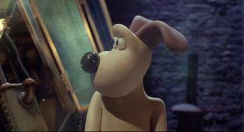 Movie still from “Wallace & Gromit: The Curse of the Were-Rabbit” (2005), directed by Nick Park – A statue of gromit the gromit from wallace and gromit; Close Up shot, Over the shoulder angle