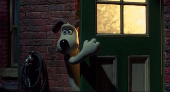 Movie still from “Wallace & Gromit: The Curse of the Were-Rabbit” (2005), directed by Nick Park – A cartoon dog standing in front of a green door; Medium shot, Over the shoulder angle