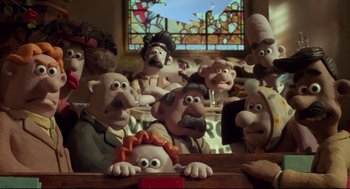 Movie still from “Wallace & Gromit: The Curse of the Were-Rabbit” (2005), directed by Nick Park – A group of people sitting in front of stained glass; Medium shot, Low angle