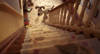 Movie still from “Wallace & Gromit: The Curse of the Were-Rabbit” (2005), directed by Nick Park – A stuffed dog is running down the stairs; Extreme Wide shot, High angle