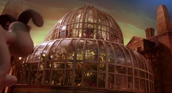 Movie still from “Wallace & Gromit: The Curse of the Were-Rabbit” (2005), directed by Nick Park – A large glass dome with plants inside of it; Extreme Wide shot, Low angle