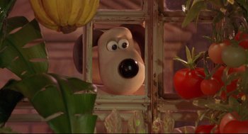 Movie still from “Wallace & Gromit: The Curse of the Were-Rabbit” (2005), directed by Nick Park – A dog looking out of a window at a tomato plant; Close Up shot, Over the shoulder angle