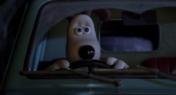 Movie still from “Wallace & Gromit: The Curse of the Were-Rabbit” (2005), directed by Nick Park – A dog's face as he drives a car; Close Up shot, High angle