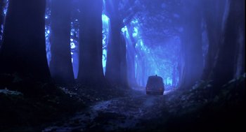Movie still from “Wallace & Gromit: The Curse of the Were-Rabbit” (2005), directed by Nick Park – A car is driving through a dark forest at night; Extreme Wide shot, Low angle
