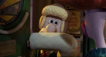 Movie still from “Wallace & Gromit: The Curse of the Were-Rabbit” (2005), directed by Nick Park – A cartoon character holding a piece of dough; Close Up shot, Over the shoulder angle