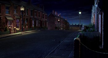 Movie still from “Wallace & Gromit: The Curse of the Were-Rabbit” (2005), directed by Nick Park – An empty street at night with a street light; Extreme Wide shot, High angle